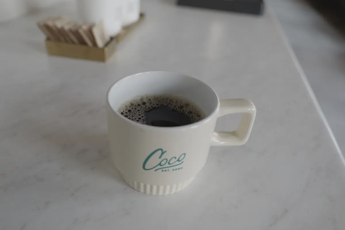 Branded mug of coffee on marble